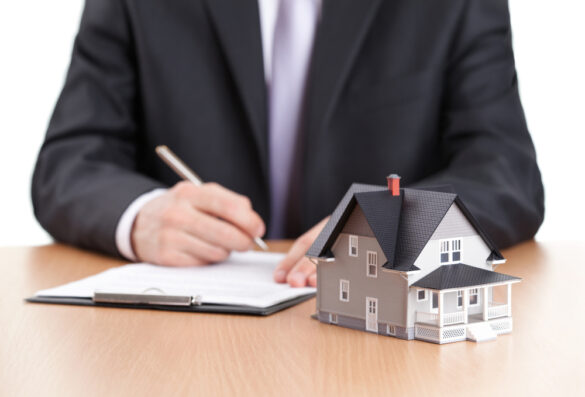 Real,Estate,Concept,-,Businessman,Signs,Contract,Behind,Home,Architectural grundbucheintrag